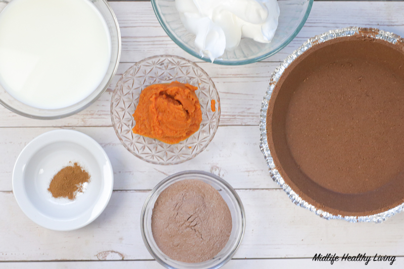 Full bunch of ingredients to make chocolate pumpkin pie. 