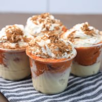 Featured image showing cups full of the finished pumpkin pie in a cup recipe.