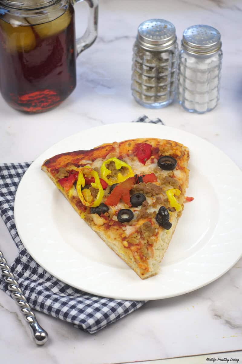 A look at a finished slice of the ground turkey pizza on a plate ready to eat