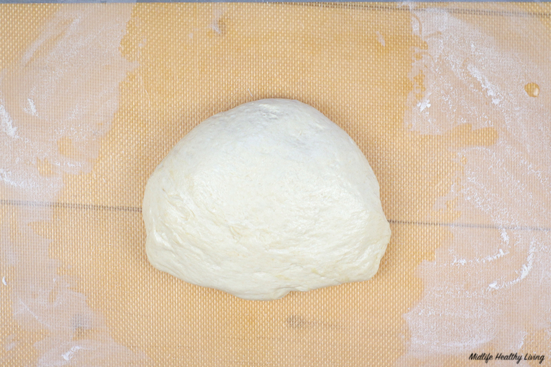 Dough ready to be rolled out for making ground turkey pizza. 
