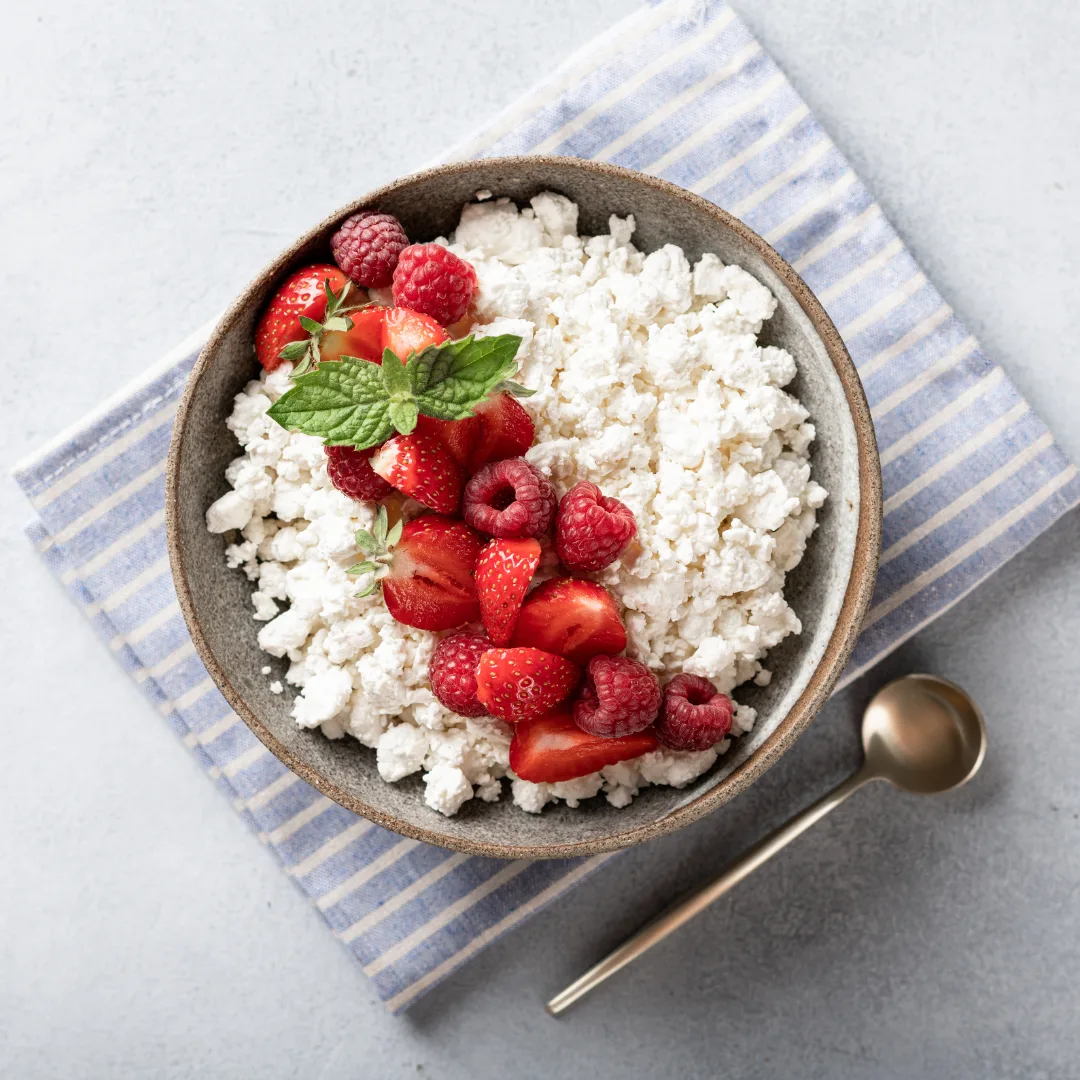cottage cheese topped with raspberries ready to eat