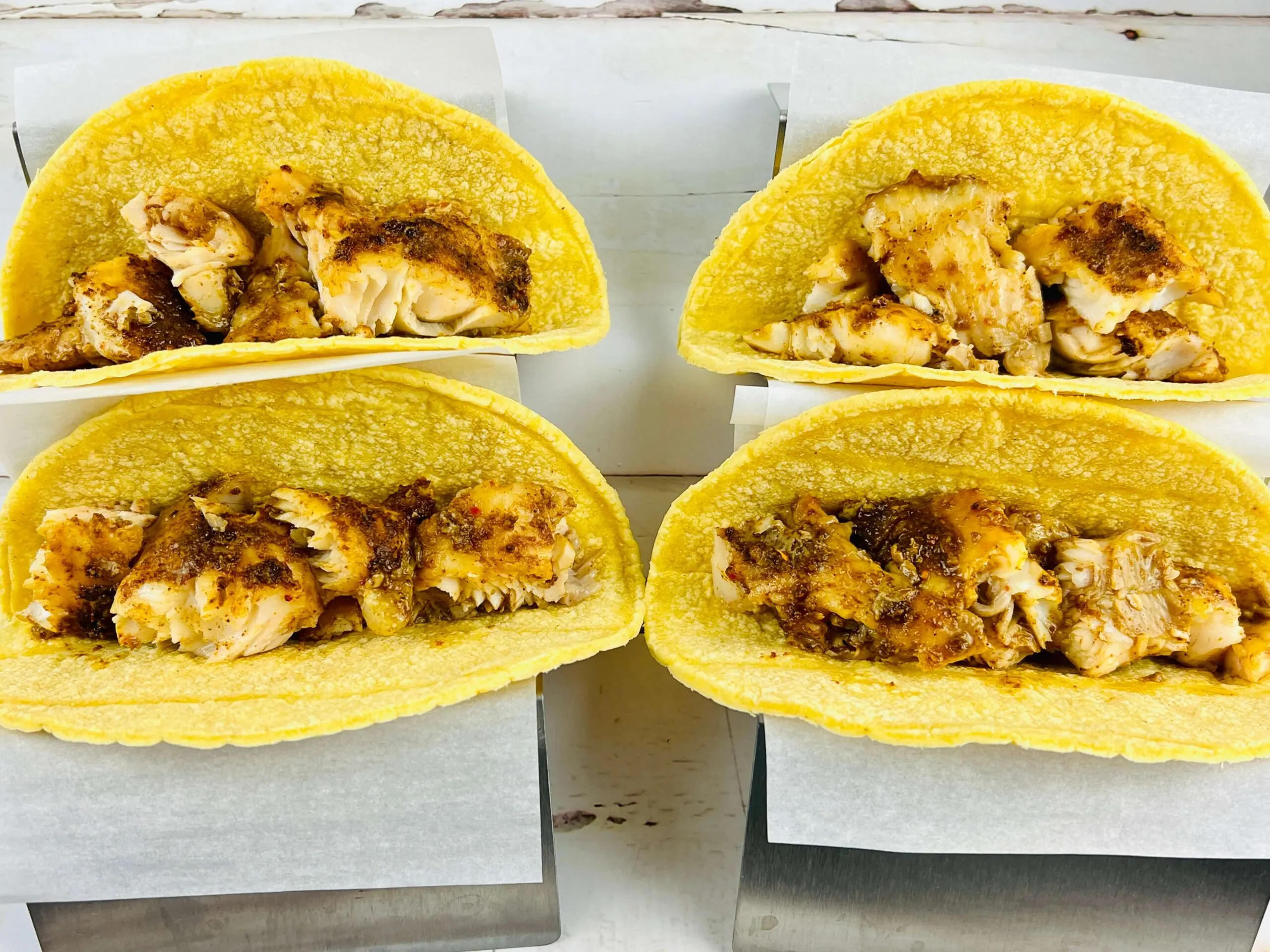 baked fish pieces in corn tortillas