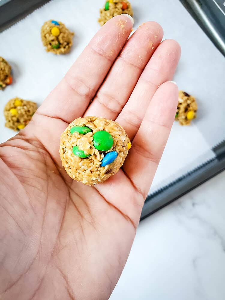 A close up of one of the chocolate peanut butter energy balls in a hand.