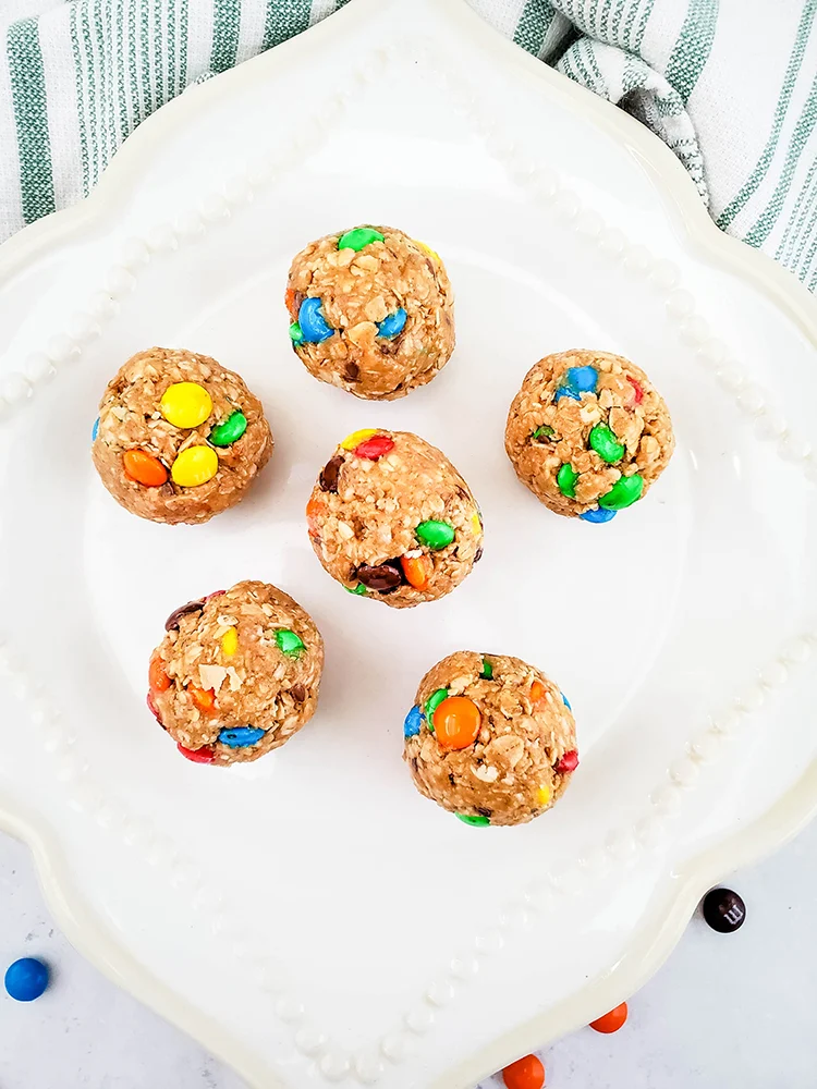 Complete energy balls on a white plate pictured from above.