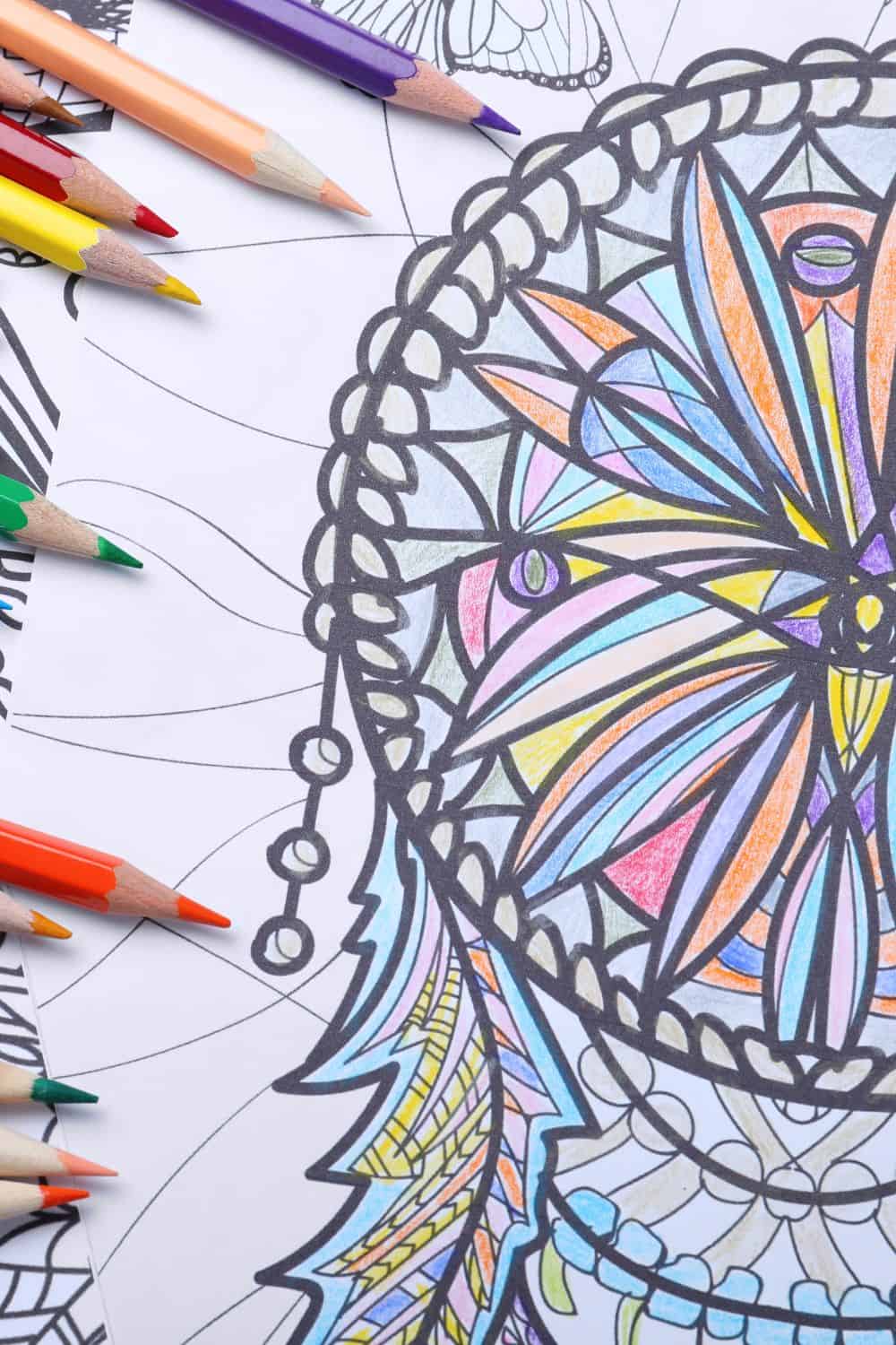 a coloring page of a dream catcher that has been colored in by the surrounding pencil crayons