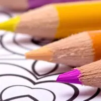 bright colored pencils on top of a printable coloring page