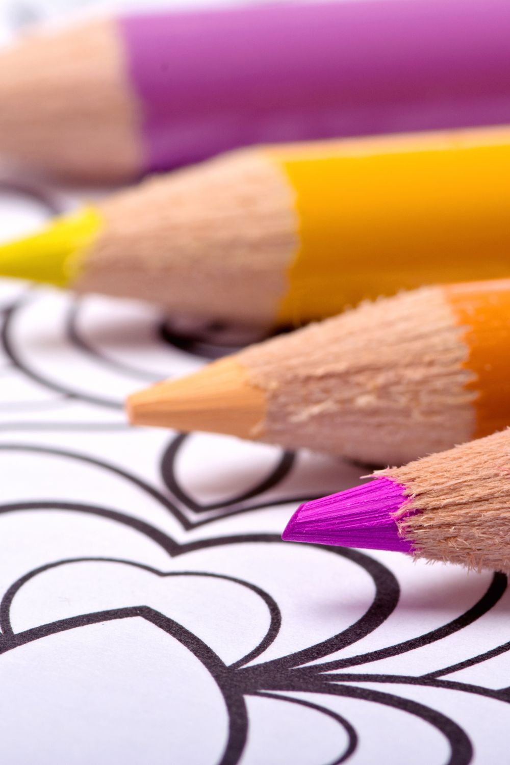 bright colored pencils on top of a printable coloring page