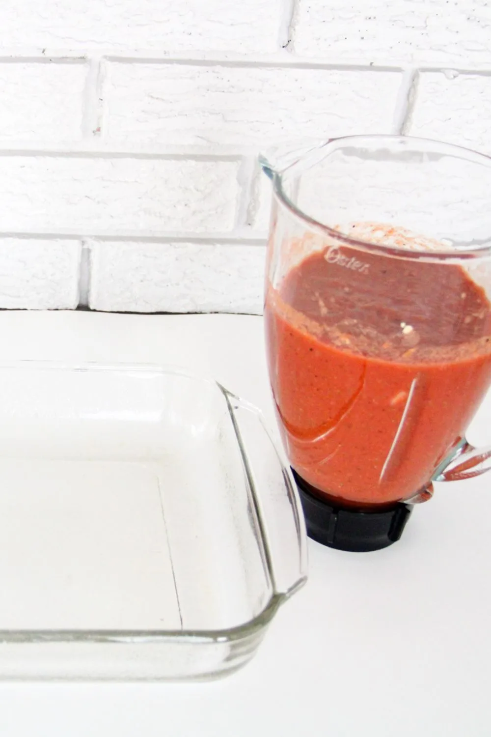 blender with blended ingredients next to a casserole dish