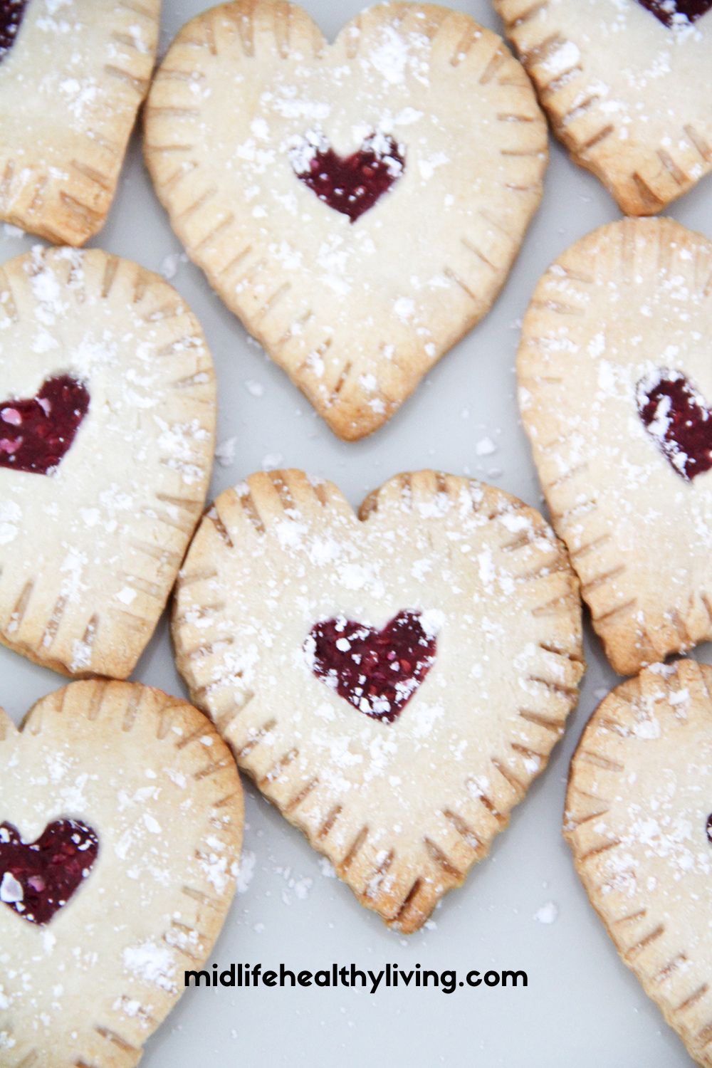 a close up of the heart shaped raspberry hand pies