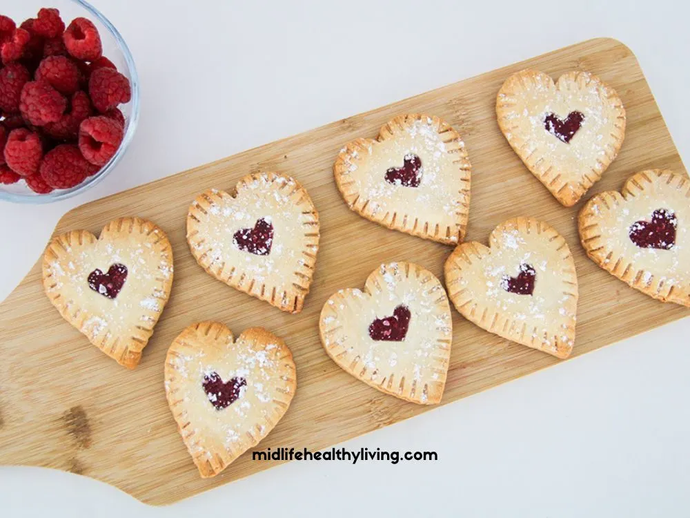 an overhead view of the raspberry hand pies on a cutting board