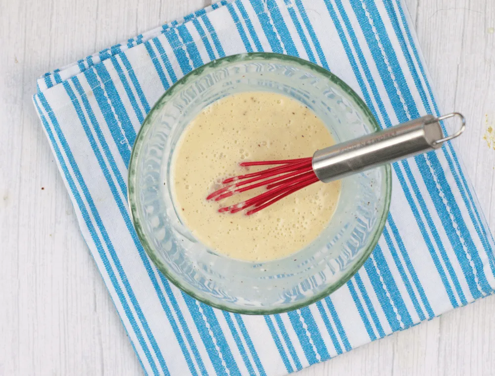 whisking together ingredients for lemon coleslaw dressing
