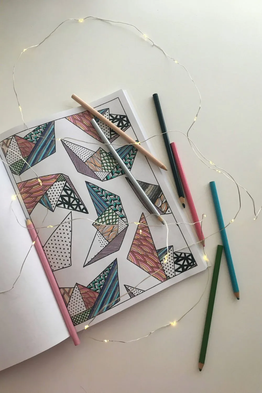 origami boat coloring page completed surrounded by cozy lights