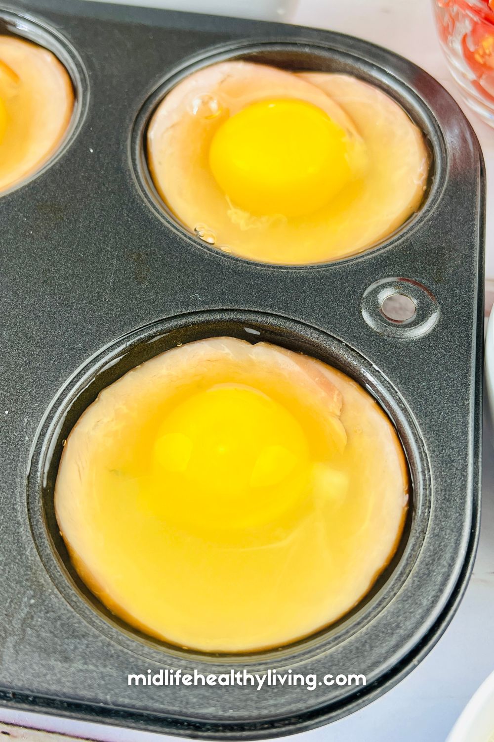 raw eggs in a muffin tin