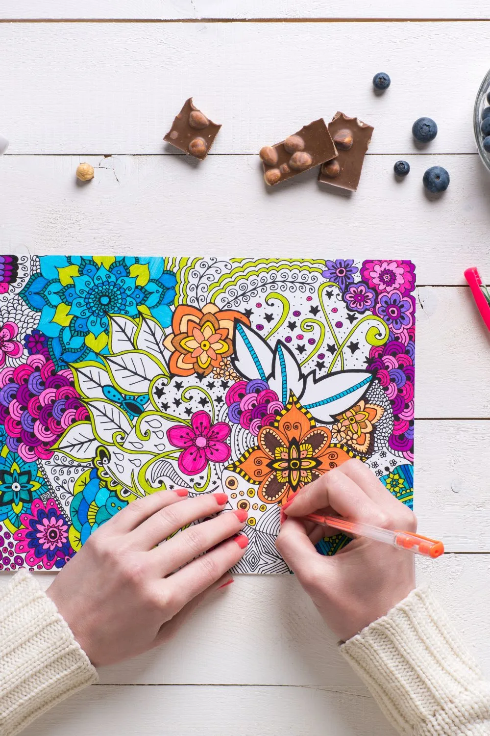 a very detailed coloring page being colored in with bright colors