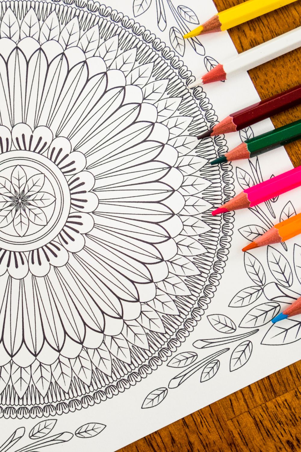 a mandala coloring page with colorful pencil crayons