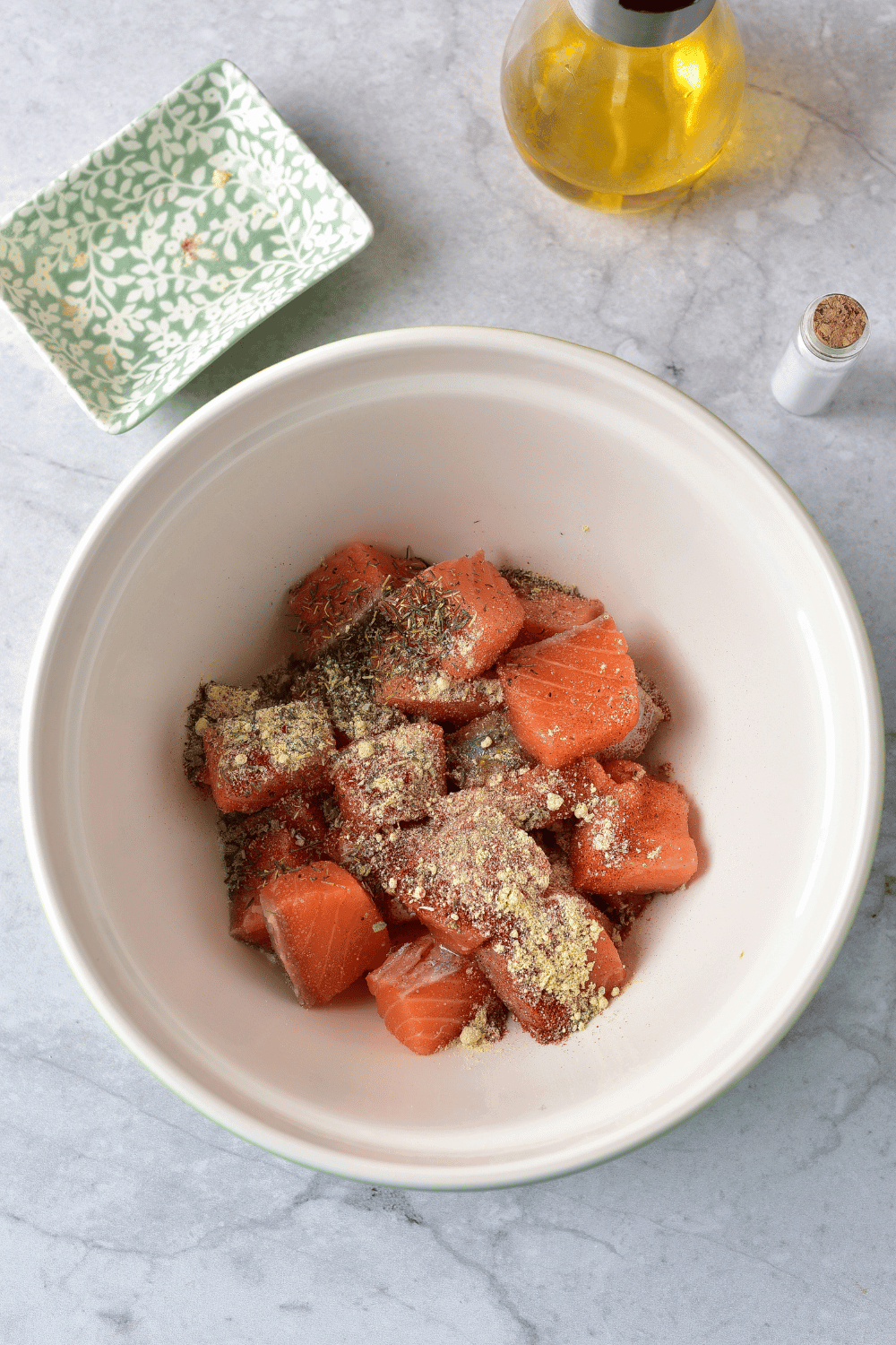 air fryer salmon bites in bowl with spices