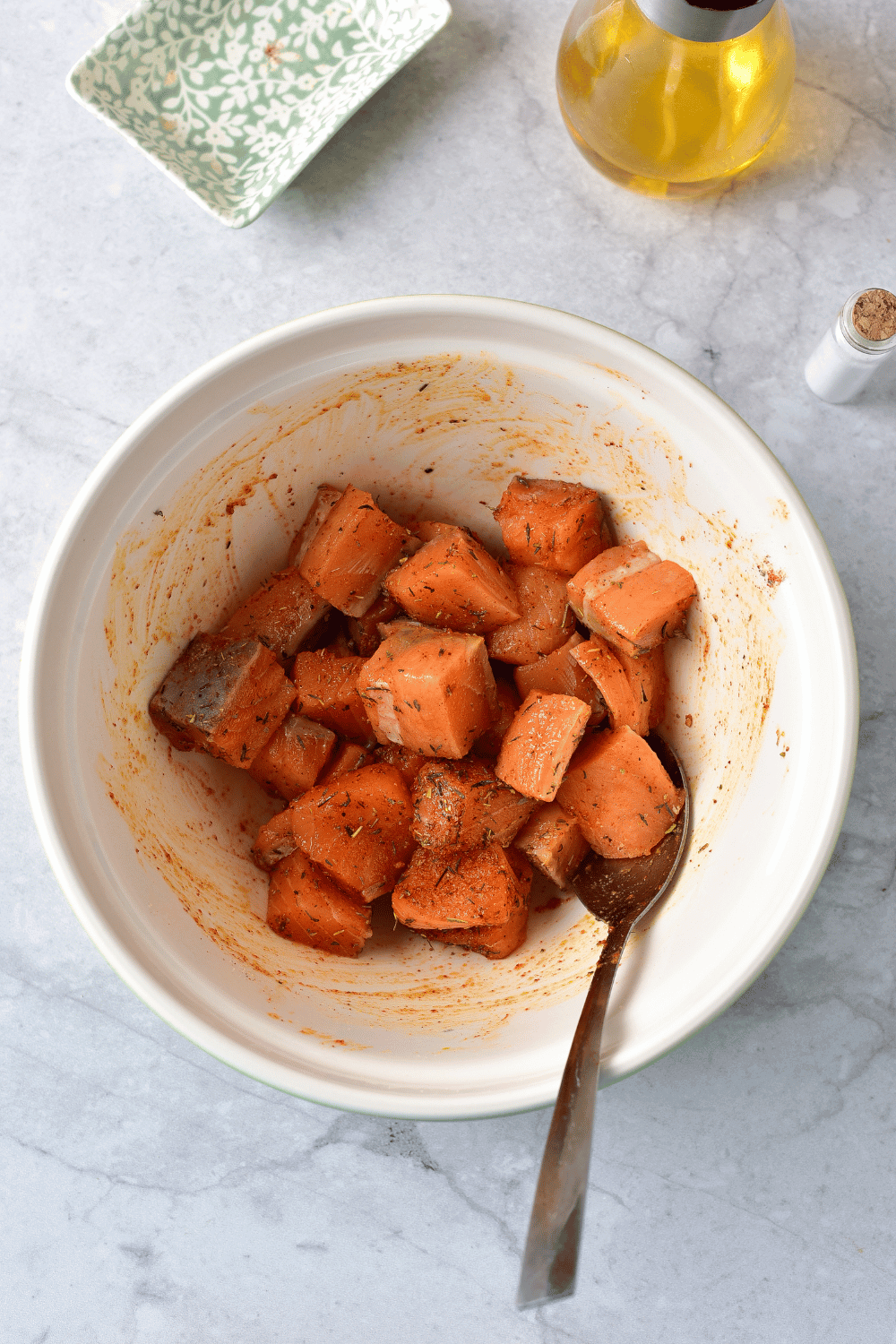 mixing air fryer salmon bites with dry spices
