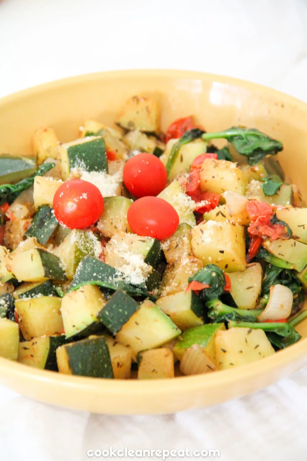 zucchini skillet meal served in a yellow bowl