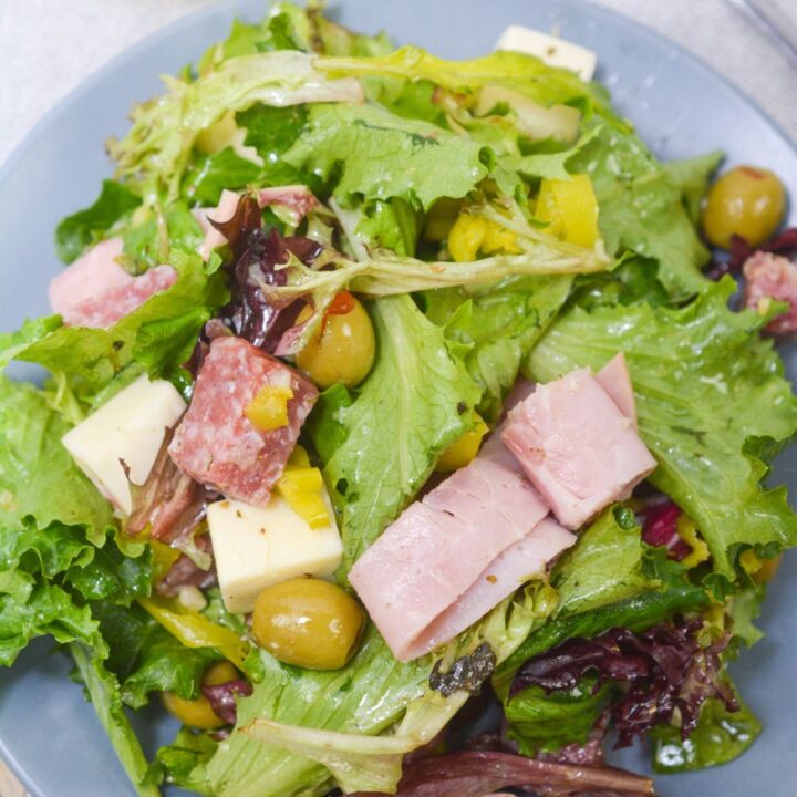 Keto friendly antipasto salad on a blue plate from above