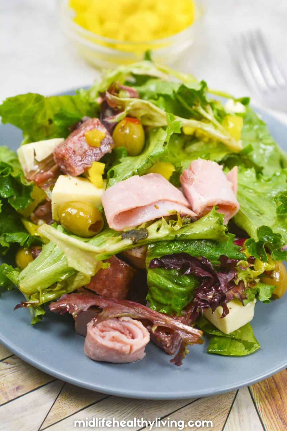 Keto friendly antipasto salad on a blue plate