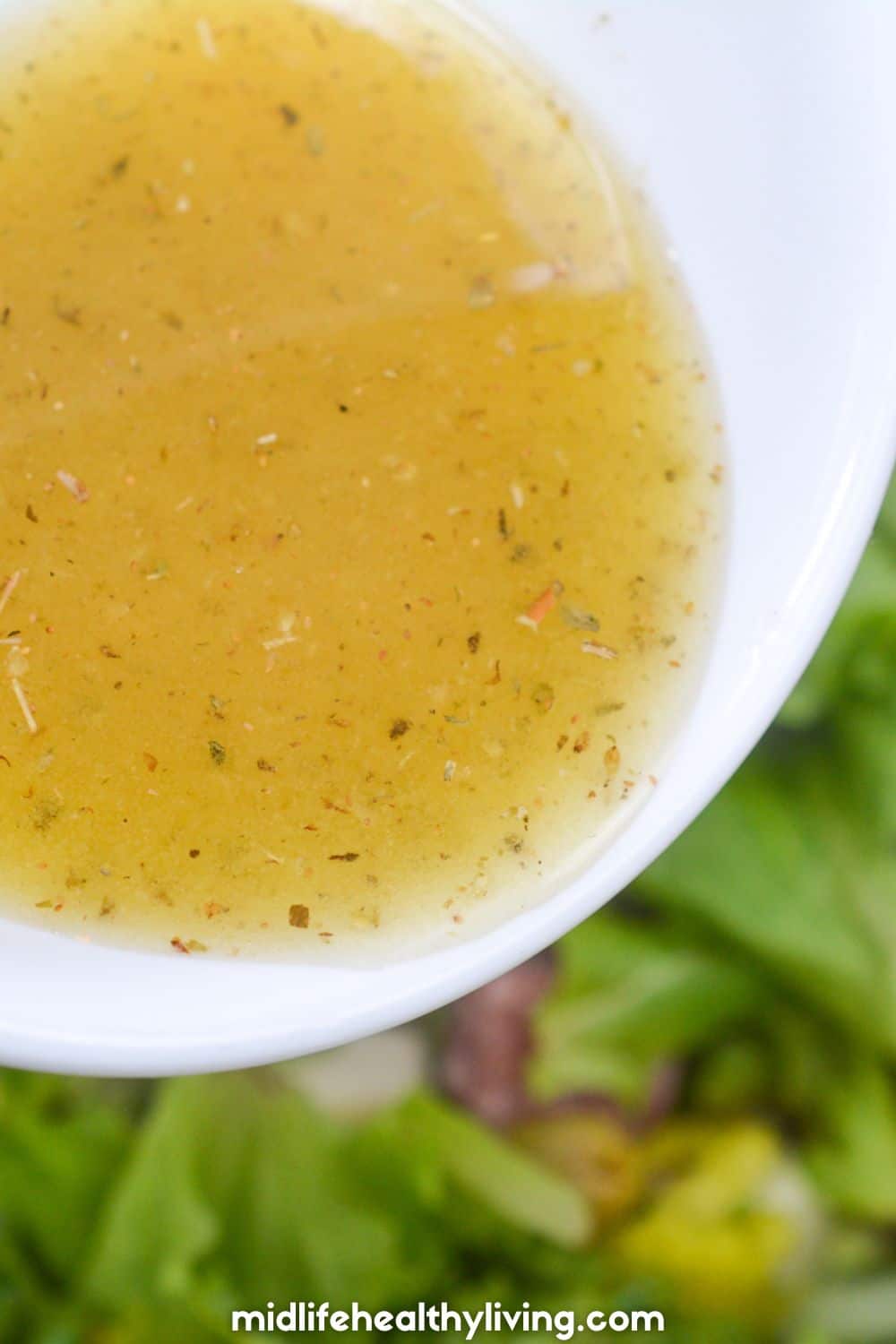 pouring dressing onto the salad