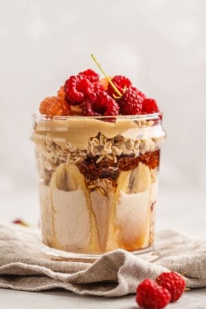 peanut butter parfait with berries on top in a jar