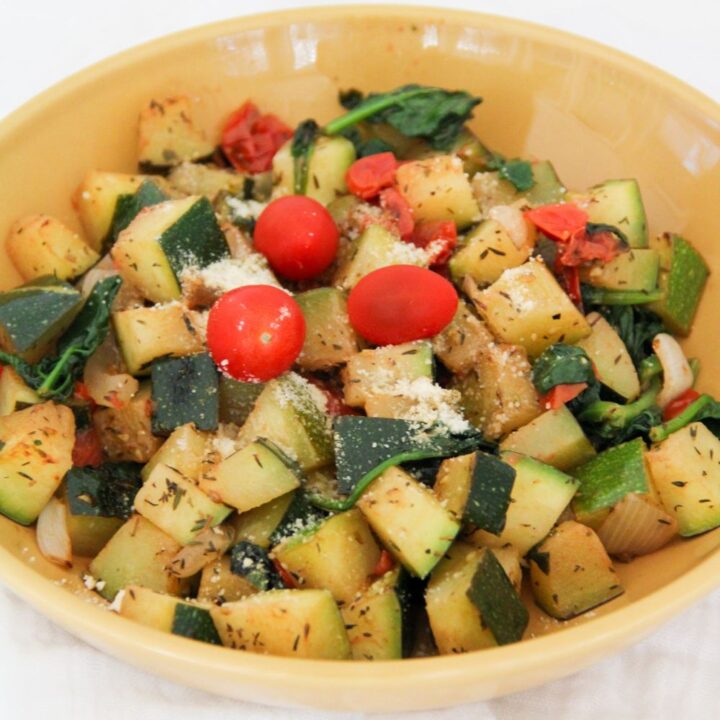 zucchini skillet meal served in a yellow bowl