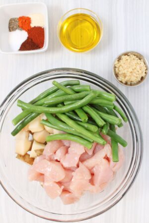 Sheet Pan Chicken Veggies raw in a bowl ready to mix