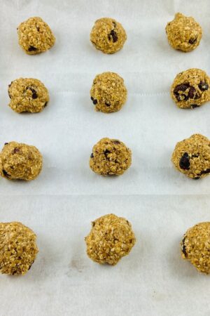 cookie dough rolled into balls on a baking sheet lined with parchment paper