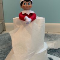 Elf on the Shelf hiding in toilet paper