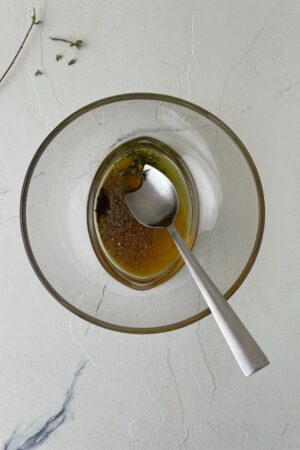 olive oil being mixed with seasoning
