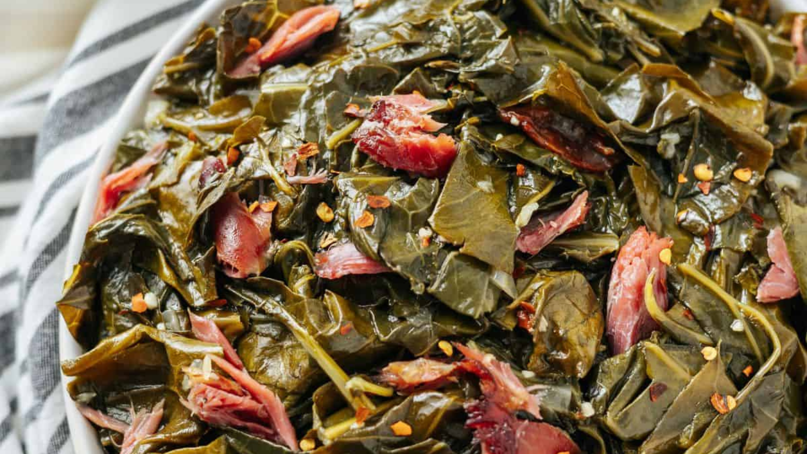 A bowl of collard greens with smoked turkey meat.