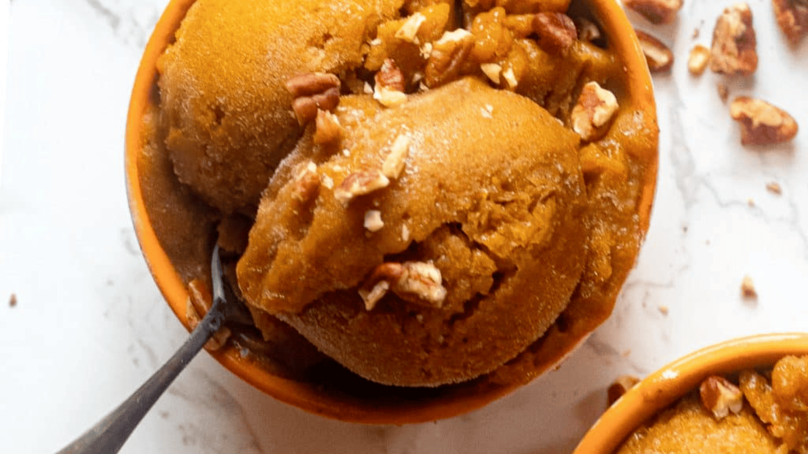 Banana pumpkin ice cream with pecans over top.