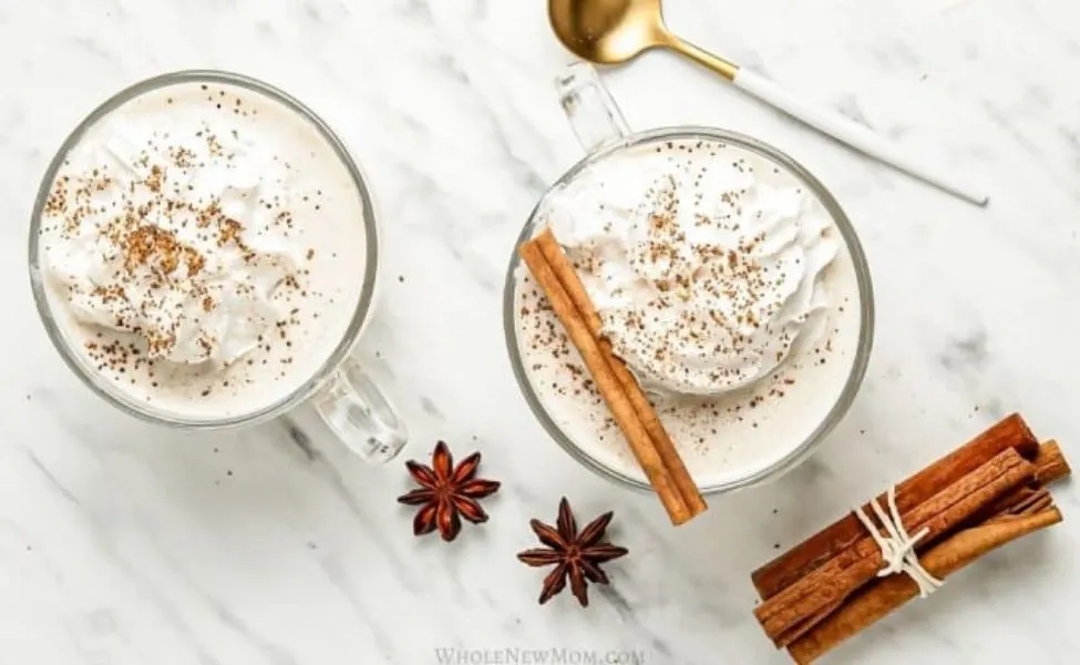 Mugs of eggnog with spices over top.