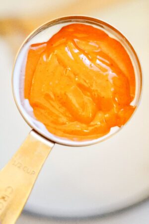 buffalo sauce in a measuring cup