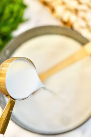 pouring heavy cream into soup