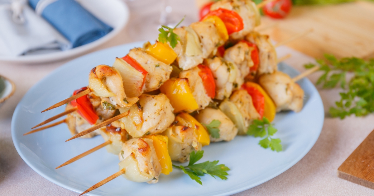 oven chicken kabobs piled on a plate